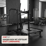 Titanium Strength Genesis Series Belt Squat in einem fertig eingerichteten Studio mit dunklen Wänden und Gummiboden