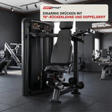 Titanium Strength Genesis Series Einarmige Schulterpresse in einem fertig eingerichteten Studio mit dunklen Wänden und Gummiboden